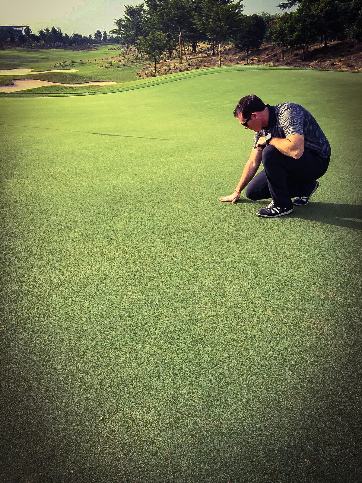 Brad Revill inspecting green at Nikanti Golf Club
